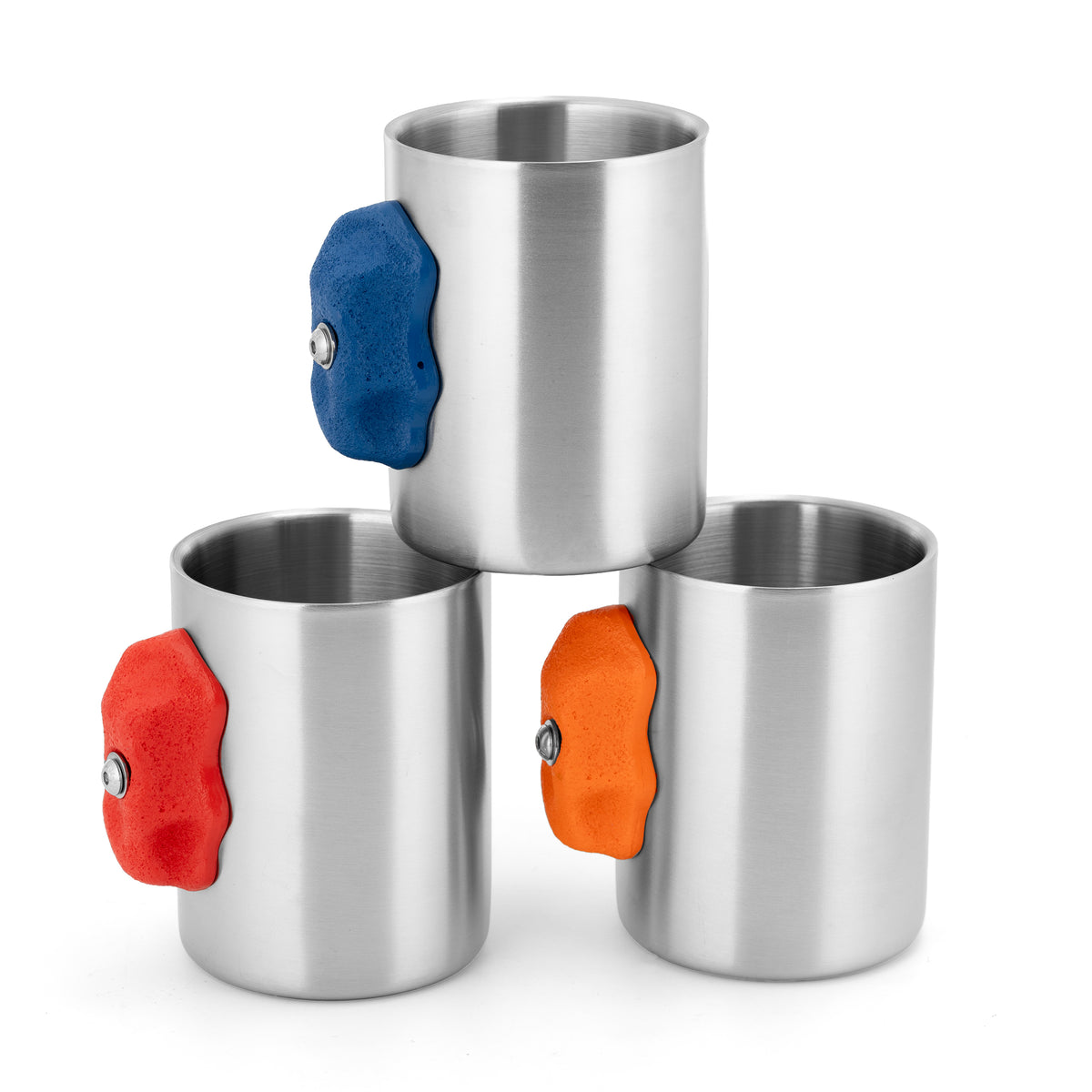 Three metal climbing hold mug colour options arranged together