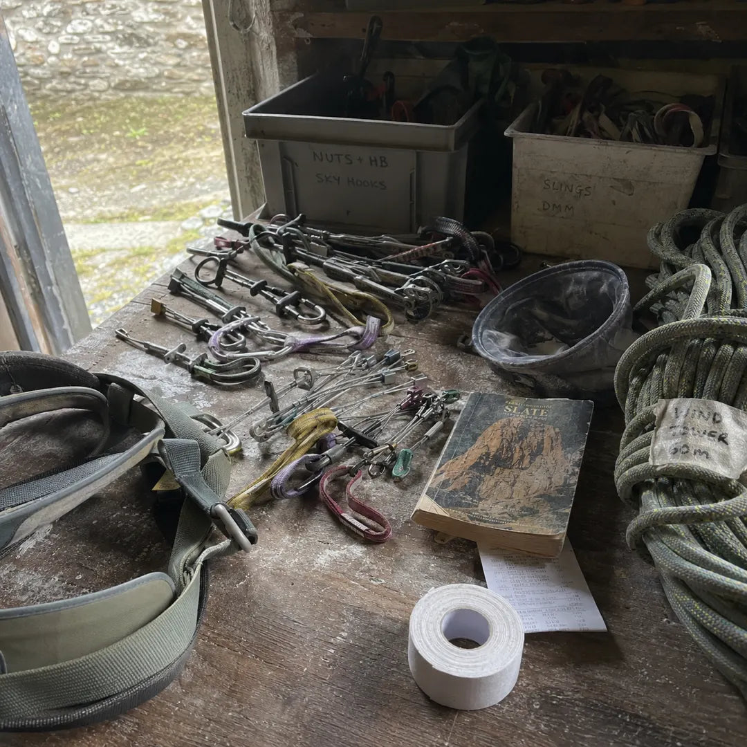 Forty years of climbing gear laid out on a workbench in Gene's shed